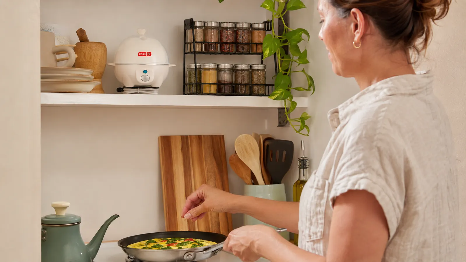 Dash Rapid Egg Cooker stored on a narrow shelf above a kitchen counter to save counter space